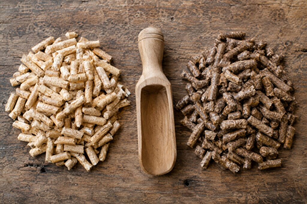 Light softwood pellets next to darker hardwood pellets