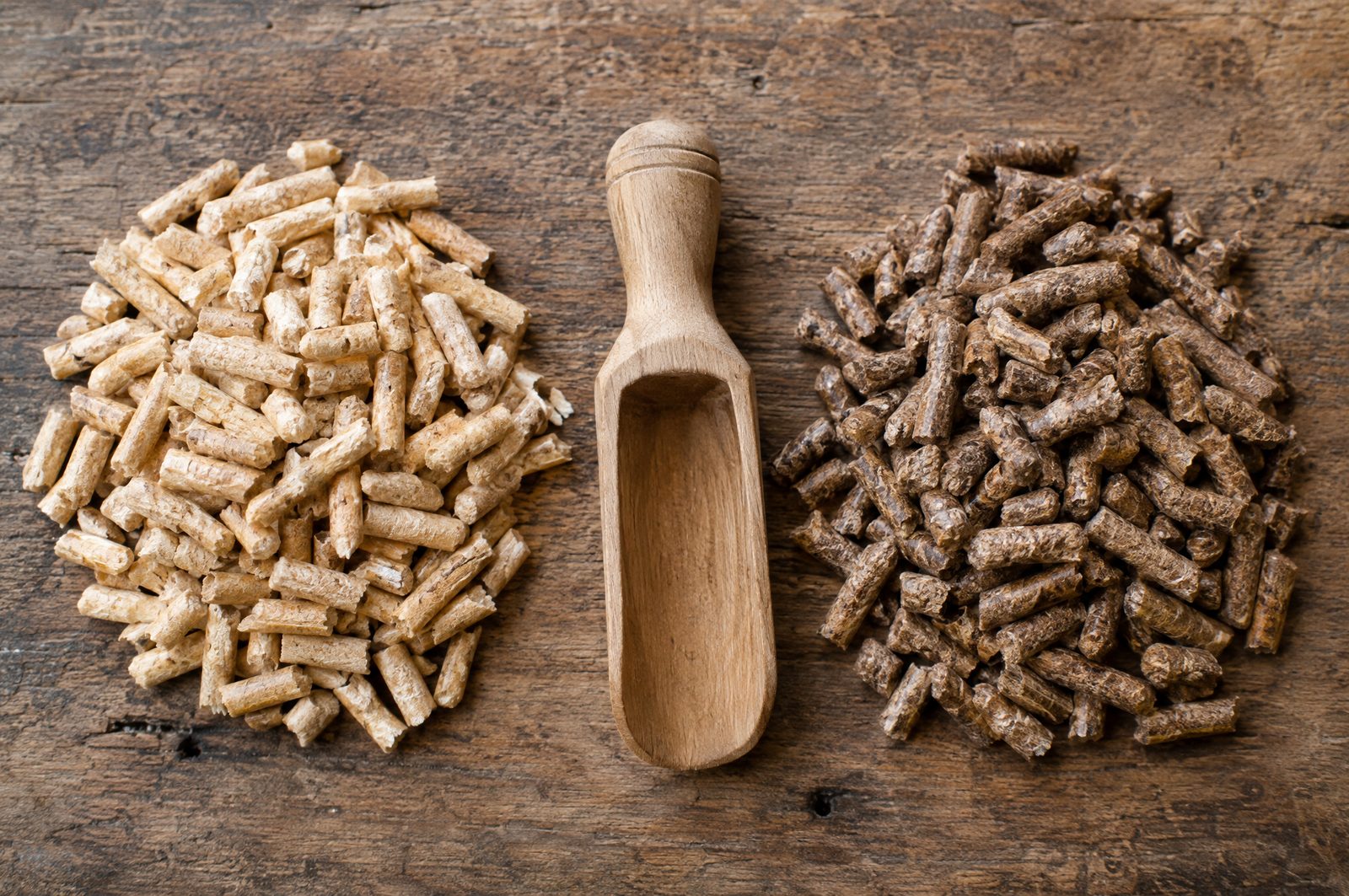 Light softwood pellets next to darker hardwood pellets